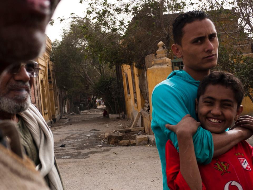 Locals who live in the City of Dead in the street at the Al Qarafa Cemetery in Cairo.