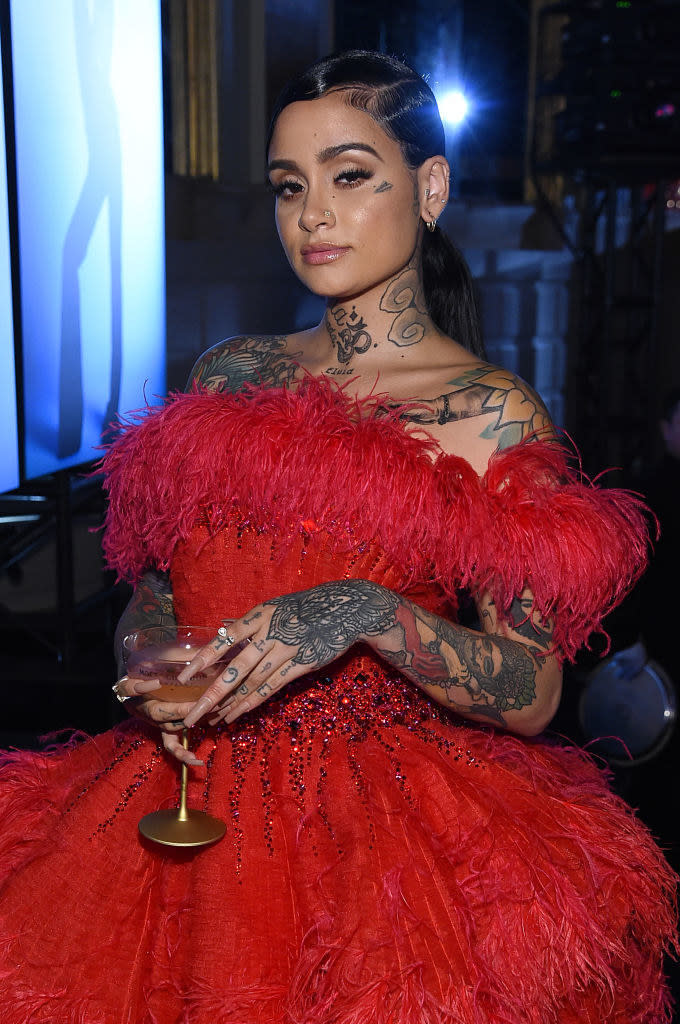 Kehlani holding a glass of champagne and wearing a fancy dress