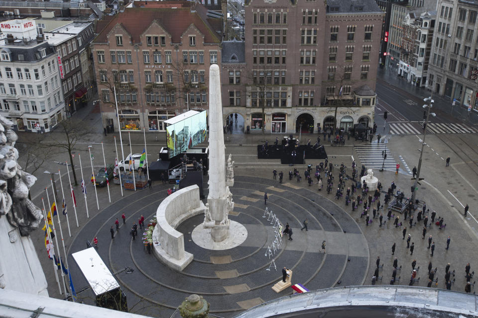 View of Dam Square devoid of spectators due to coronavirus related restrictions, as Dutch King Willem-Alexander and Queen Maxima lay a wreath during a national service to commemorate the war dead in Amsterdam, Netherlands, Tuesday, May 4, 2021. (AP Photo/Peter Dejong, Pool)