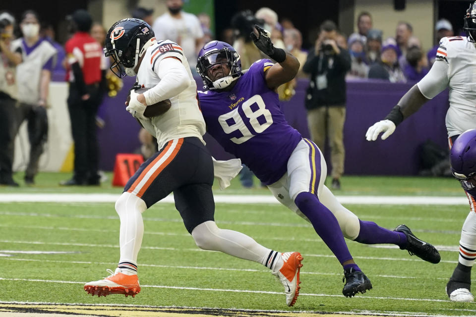 Chicago Bears quarterback Andy Dalton (14) is sacked by Minnesota Vikings defensive end D.J. Wonnum (98) during the first half of an NFL football game, Sunday, Jan. 9, 2022, in Minneapolis. (AP Photo/Jim Mone)