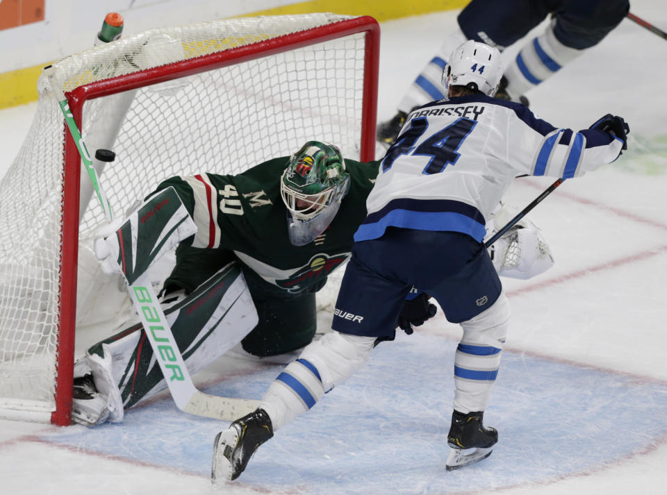 Winnipeg Jets defenseman Josh Morrissey (44) scores the game winning goal past Minnesota Wild goalie Devan Dubnyk (40) in overtime of an NHL hockey game Sunday, Sept. 29, 2019 in St. Paul, Minn. The Jets defeated the Wild 5-4. (AP Photo/Andy Clayton-King)