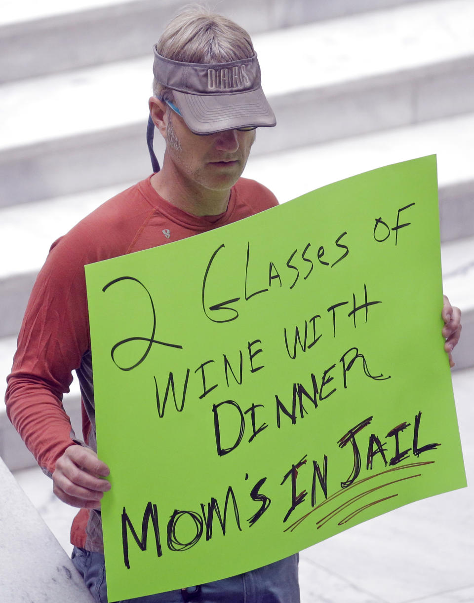 FILE - In this March 17, 2017, file photo, a protester holds a sign during a rally concerning the DUI threshold at the Utah State Capitol in Salt Lake City. New Year's Eve revelers in Utah may find themselves with more than a hangover as 2019 dawns: If they drink and drive, they could get hit by the newest and lowest DUI threshold in the nation. The .05 percent limit goes into effect Dec. 30, despite protests that it will punish responsible drinkers, hurt the state's tourism industry and amplify its alcohol-unfriendly reputation. (AP Photo/Rick Bowmer, File)