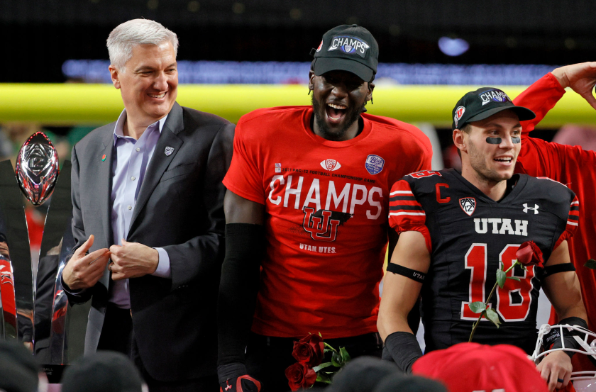 LAS VEGAS, NEVADA - DECEMBER 03: (L-R) Pac-12 Commissioner George Kliavkoff stands next to MVP linebacker Devin Lloyd.