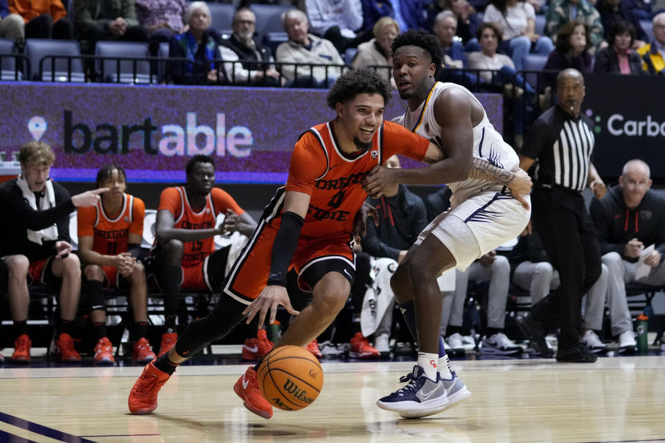 Oregon State guard Jordan Pope, left, gets past California guard Jalen Cone during the second half of an NCAA college basketball game Thursday, Feb. 22, 2024, in Berkeley, Calif. (AP Photo/Godofredo A. Vásquez)