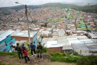 Colombian soldiers stand guard at the Ciudad Bolivar slum outside Bogota -- it is home to 700,000 people