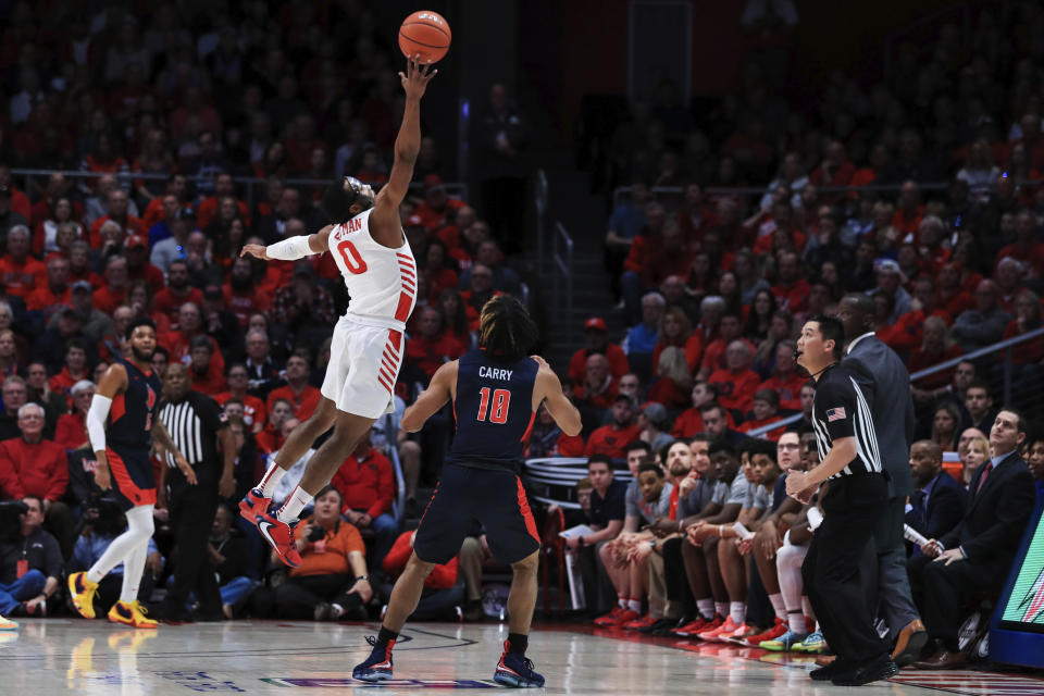 Dayton's Zimi Nwokeji (0) leaps as he knocks the ball out of bounds against Duquesne's Sincere Carry (10) in the first half of an NCAA college basketball game, Saturday, Feb. 22, 2020, in Dayton, Ohio. (AP Photo/Aaron Doster)