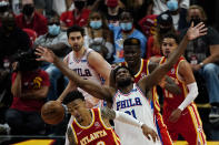 Atlanta Hawks forward John Collins (20), front, and Philadelphia 76ers center Joel Embiid (21) vie for the ball as teammates look on during the second half of Game 3 of a second-round NBA basketball playoff series, Friday, June 11, 2021, in Atlanta. (AP Photo/John Bazemore)