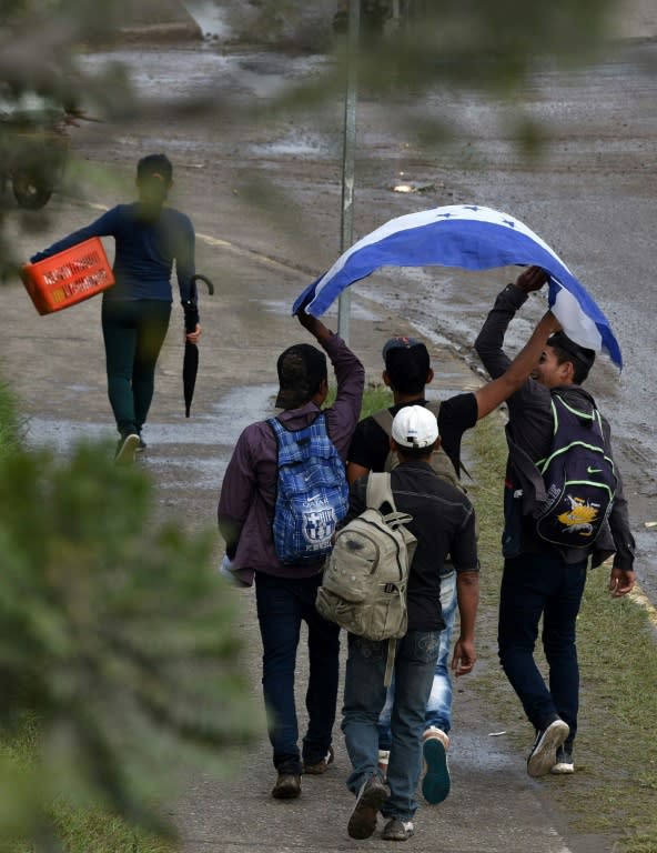 Honduran migrants taking part in the caravan walk through Santa Rosa de Copan on their way to the border with El Salvador