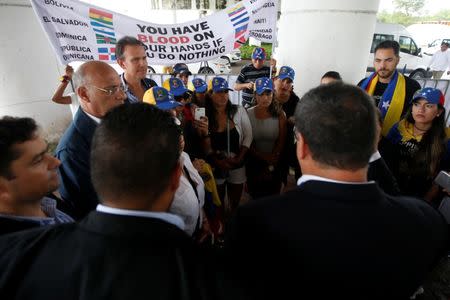 Venezuelan opposition lawmakers talk to a small group of Venezuela protesters outside the site where the Organization of American States (OAS) 47th General Assembly is taking place in Cancun, Mexico June 21, 2017. REUTERS/Carlos Jasso