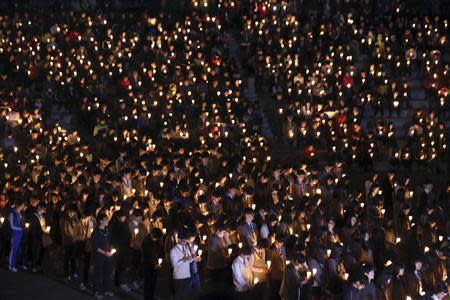 Students from Danwon high school and other people attend a candlelight vigil to wish for the safe return of missing passengers from the South Korean ferry "Sewol", which sank in the sea off Jindo, at a park in Ansan April 19, 2014. REUTERS/Park Jung-ho/News1