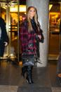 <p>The star wore a tartan oversized coat and chic leather-look books to brave the chilly NYC December temperatures.</p>