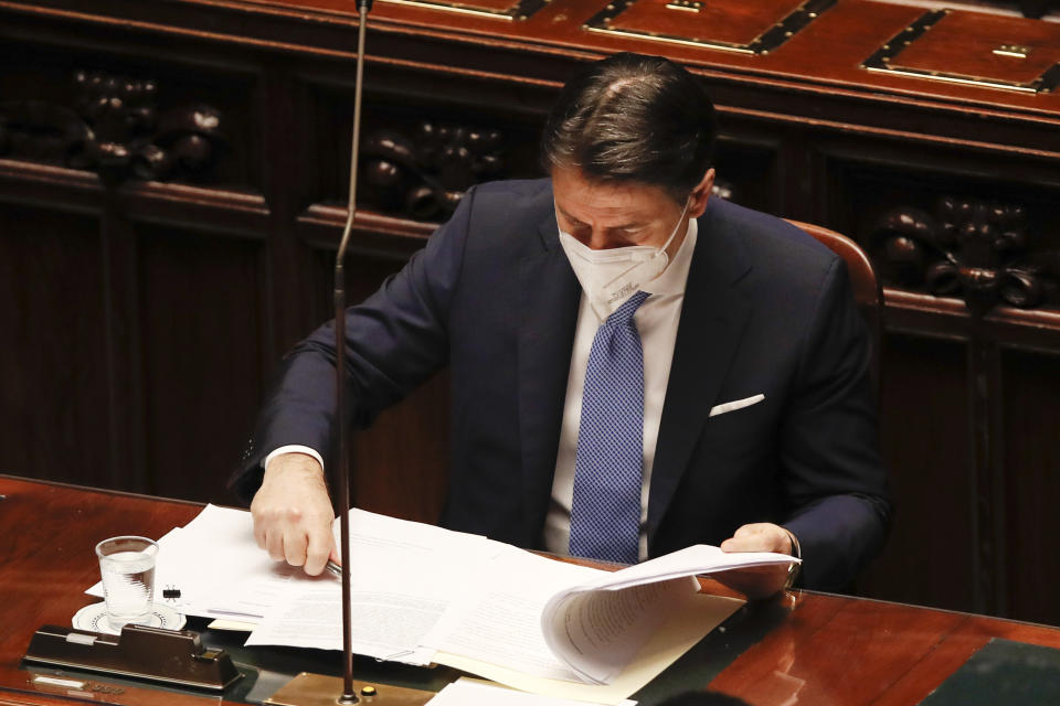 Premier Giuseppe Conte looks at papers prior to delivering his speech at the lower chamber of Parliament, in Rome, Monday, Jan. 18, 2021. Conte fights for his political life with an address aimed at shoring up support for his government, which has come under fire from former Premier Matteo Renzi's tiny but key Italia Viva (Italy Alive) party over plans to relaunch the pandemic-ravaged economy. (AP Photo/Alessandra Tarantino, pool)