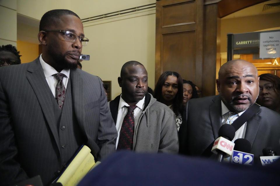 Co-civil counsel Trent Walker, right, comments on the sentencing of six former Mississippi law enforcement officers, as Eddie Terrell Parker center, and lead civil attorney Malik Shabazz, left, listen, Wednesday, April 10, 2024, in Brandon, Miss. Parker and his friend Michael Corey Jenkins, unseen, were the subjects of racially motivated torture in 2023 by the then lawmen. (AP Photo/Rogelio V. Solis)