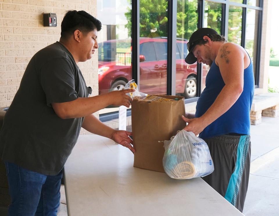 Employee Chayanna Salana helps Brady Williams, who has an 8 month old and a 2 year old, picks up supplies, including baby formula, at Infant Crisis Services during a baby formula shortage, Friday, May 13, 2022