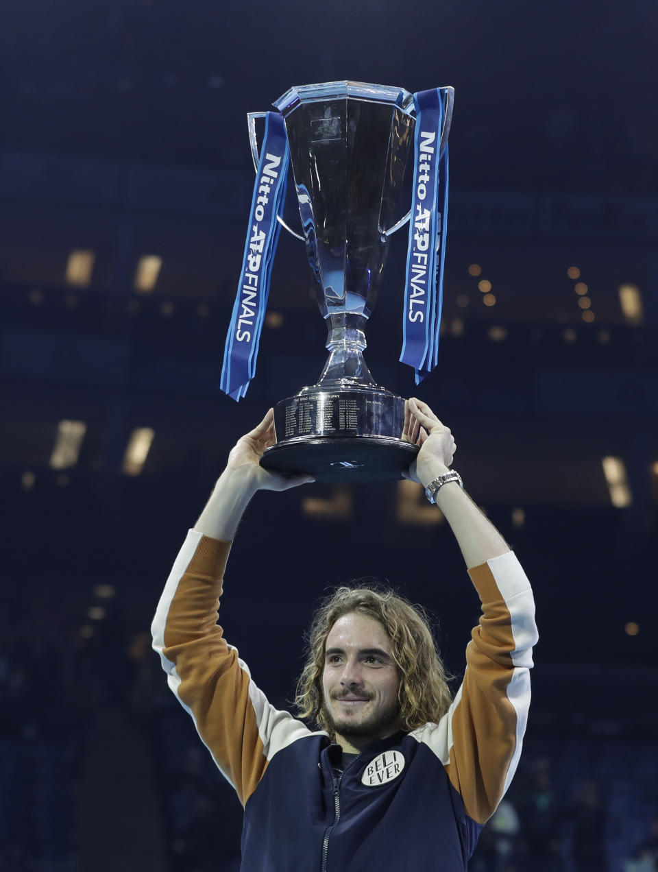 Stefanos Tsitsipas of Greece holds up the trophy and celebrates after defeating Austria's Dominic Thiem in the final of the ATP World Finals tennis match at the O2 arena in London, Sunday, Nov. 17, 2019. (AP Photo/Kirsty Wigglesworth)