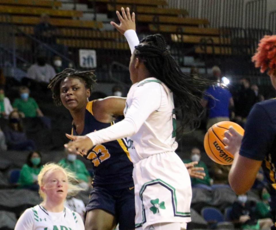 Keenan’s MiLaysia Fulwiley (23) passes behind her back to Keenan’s Tamyra Davis (13) during the 3A state championship game at the USC Aiken Convocation Center on Friday, March 5, 2021.