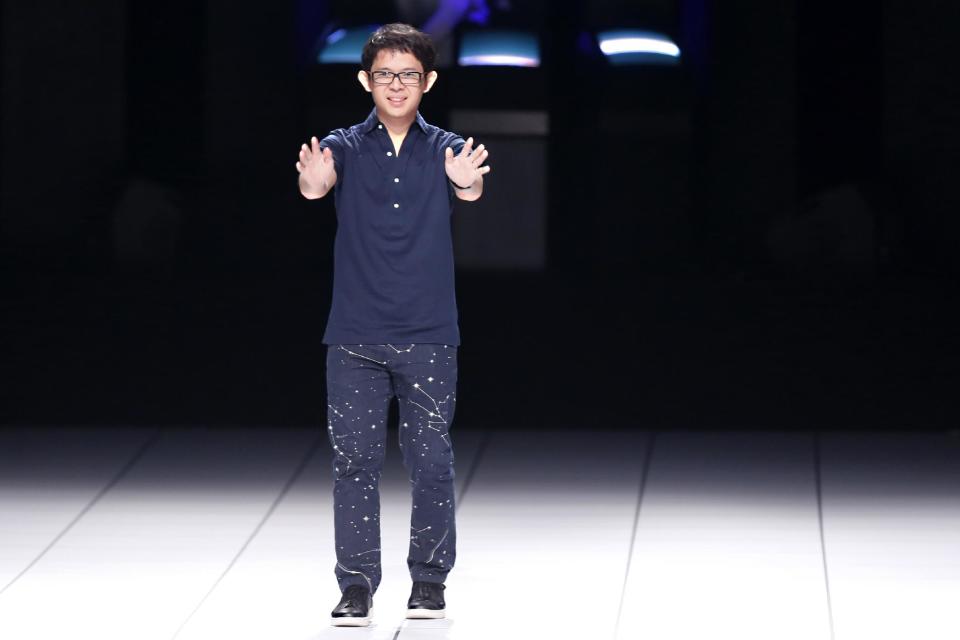 Japanese fashion designer Yoshiyuki Miyamae acknowledges applause following the presentation of the ready-to-wear Spring/Summer 2014 fashion collection he designed for Issey Miyake, Friday, Sept. 27, 2013 in Paris. (AP Photo/Jacques Brinon)