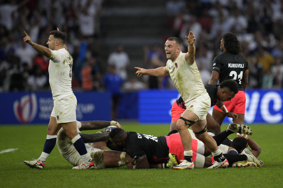 England's Ben Earl and Danny Care, left, celebrate winning during the Rugby World Cup quarterfinal match between England and Fiji at the Stade de Marseille in Marseille, France, Sunday, Oct. 15, 2023. (AP Photo/Daniel Cole)