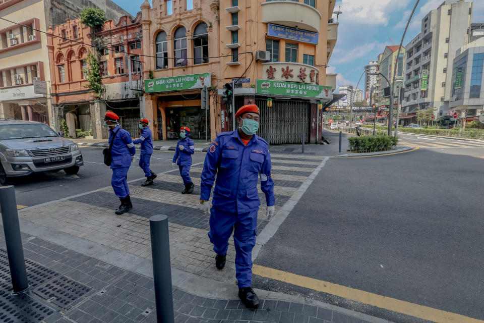 Malaysia Civil Defence Force patrol in Kuala Lumpur, on March 20, 2020, as Malaysia enters the third day of a two-week shutdown to combat the Covid-19 outbreak. (Photo by Mohd Daud/NurPhoto via Getty Images)