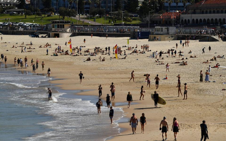 People walk at Bondi Beach, as more than 80 per cent of New South Wales remains in strict lockdown as the state struggles to bring a Covid surge under control, in Sydney, Australia on 11 August 2021 - Joel Carrett/Shutterstock