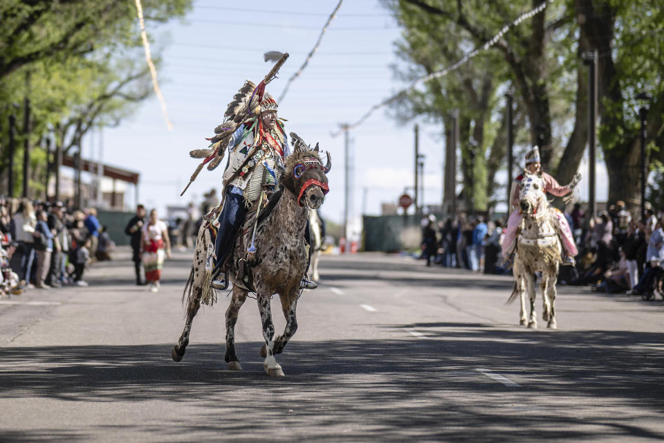 Shane Redhawk who is Sicangu Lakota leads a horse parade at the 40th anniversary of the Gathering of Nations Pow Wow in Albuquerque, N.M., Friday, April 28, 2023. Tens of thousands of people gathered in New Mexico on Friday for what organizers bill as the largest powwow in North America. (AP Photo/Roberto E. Rosales)