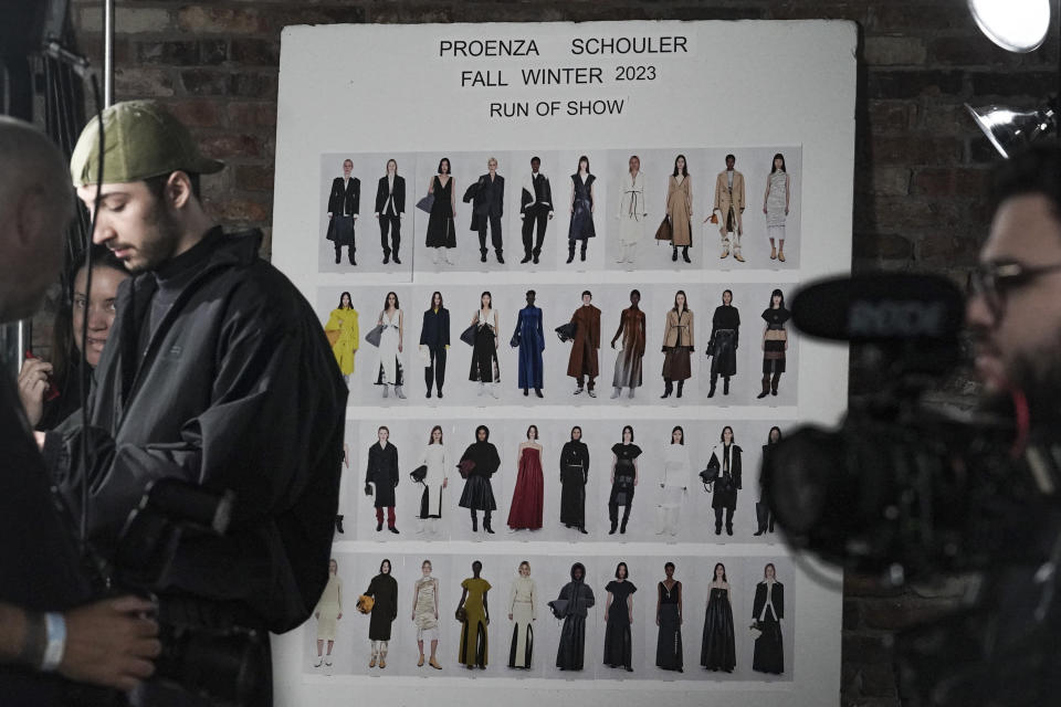 Fashion from Proenza Schouler latest collection is displayed backstage on a run-of-show board, during Fashion Week, Saturday Feb. 11, 2023 in New York. (AP Photo/Bebeto Matthews)