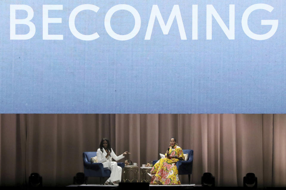 Former first lady Michelle Obama, left, and Tracee Ellis Ross speak at the "Becoming: An Intimate Conversation with Michelle Obama" event at the Forum on Thursday, Nov. 15, 2018, in Inglewood, Calif. (Photo by Willy Sanjuan/Invision/AP)