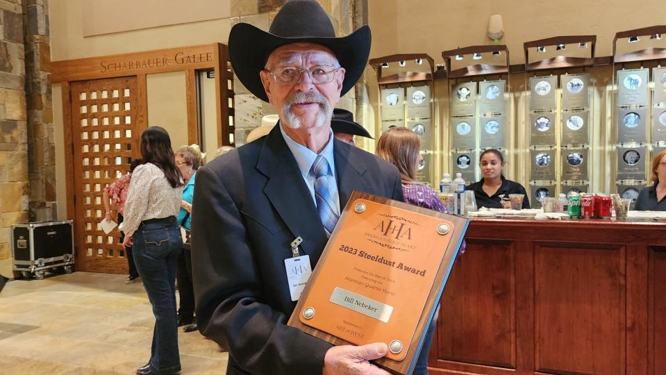 Arizona artist Bill Nebeker holds this year's Steeldust Award for best in show at the Aug. 12 AQHA Art Show in Amarillo.