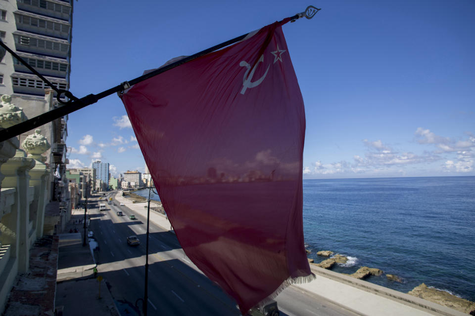 A Soviet Union flag hangs from the facade of Paladar Nazdarovie, a soviet-themed restaurant that is currently closed for repairs in Havana, Cuba, Friday, Oct. 11, 2019. Observers of Cuban and Russian foreign policy say there is a significant warming between the former partners, prompted in part by the Trump administration’s reversal of President Barack Obama’s opening to Cuba. (AP Photo/Ismael Francisco)