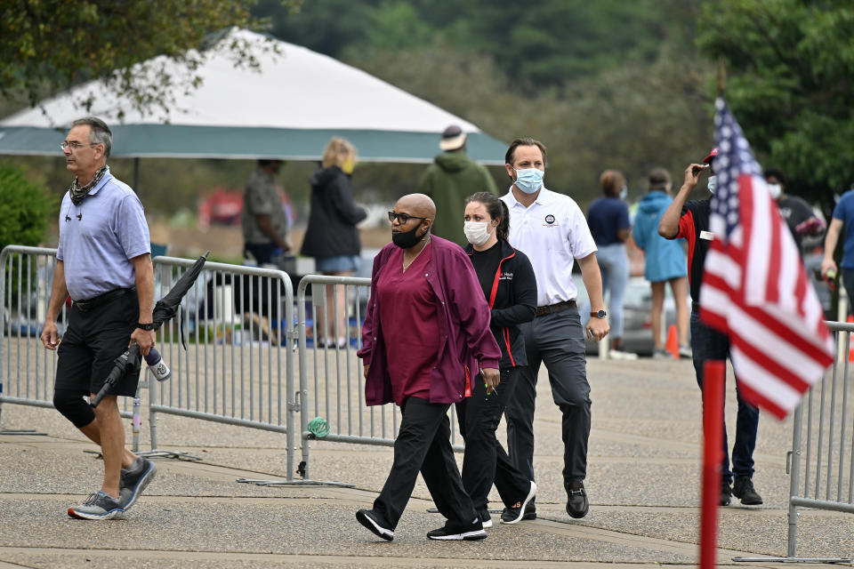 A steady stream of voters file into the Kentucky Exposition Center to cast their vote in the Kentucky primary in Louisville, Ky., Tuesday, June 23, 2020. In an attempt to prevent the spread of the coronavirus, neighborhood precincts were closed and voters that didn't cast mail in ballots were directed to one central polling location. (AP Photo/Timothy D. Easley)