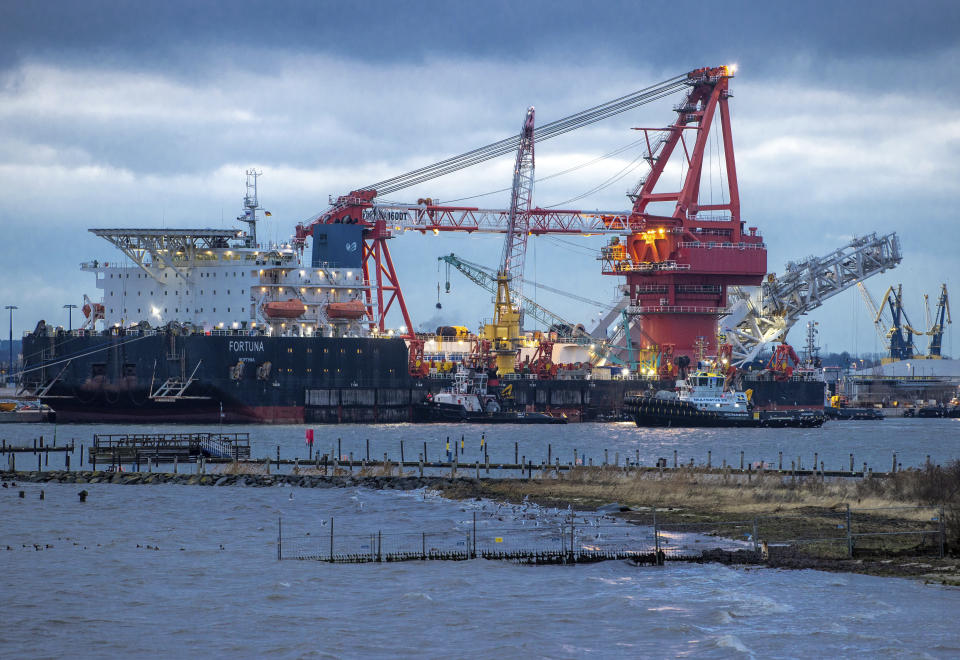 FILE - In this Jan. 14, 2021 file photo, Tugboats get into position on the Russian pipe-laying vessel "Fortuna" in the port of Wismar, Germany, Thursday, Jan 14, 2021. The special vessel is being used for construction work on the German-Russian Nord Stream 2 gas pipeline in the Baltic Sea. The company building a disputed Russian-German subsea pipeline says work on the gas pipeline has resumed, the German news agency dpa reports. Construction on the Nord Stream 2 pipeline was resumed late Saturday, dpa reported Sunday. ( Jens Buettner/dpa via AP, File)