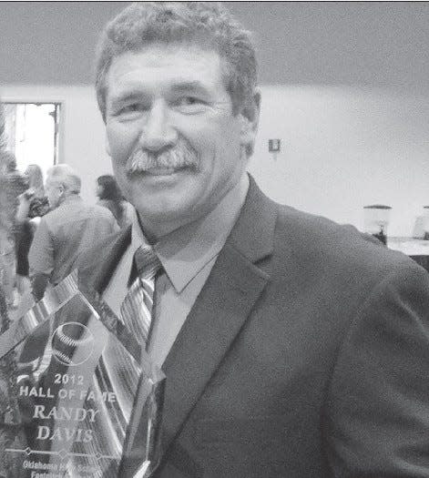 Copan High softball coach Randy Davis displays his plaque for being inducted in the early 2010s into the Oklahoma Softball Coaches Association Hall of Fame.