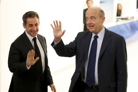 File photo of Nicolas Sarkozy (L), newly elected head of the French conservative party UMP party, who accompanies French politician Alain Juppe, former prime minister and Mayor of Bordeaux, after a meeting at the party headquarters in Paris December 3, 2014. REUTERS/Charles Platiau/File Photo