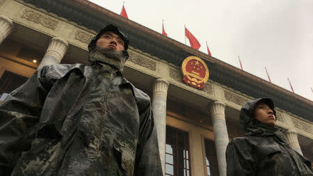 Chinese soldiers stand guard outside the Great Hall of the People before the opening of the 19th National Congress of the Communist Party of China at the Great Hall of the People in Beijing, China October 18, 2017. REUTERS/Jason Lee