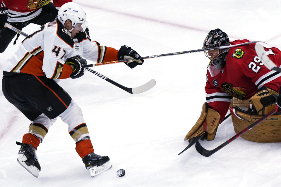 Chicago Blackhawks goaltender Marc-Andre Fleury, right, saves a shot by Anaheim Ducks defenseman Hampus Lindholm during the third period of an NHL hockey game in Chicago, Saturday, Jan. 15, 2022. (AP Photo/Nam Y. Huh)