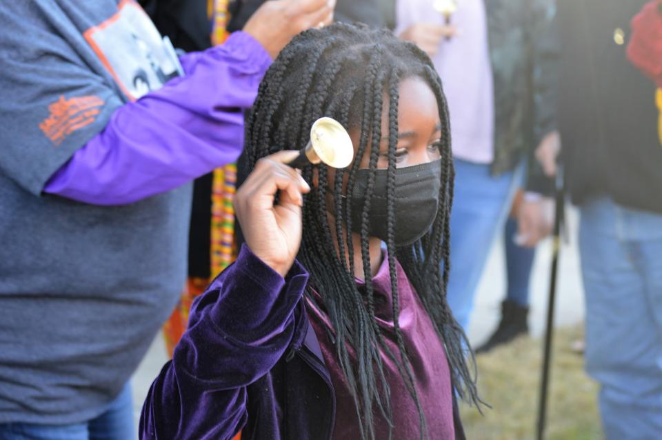 Shiloh Ilboudo, 9, rings her bell during a bell ringing ceremony outside of Old City Hall in honor of civil rights leader Martin Luther King Jr. in January, 2022.