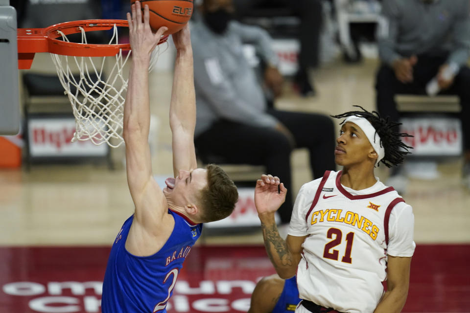 Kansas guard Christian Braun drives to the basket ahead of Iowa State guard Jaden Walker (21) during the second half of an NCAA college basketball game, Saturday, Feb. 13, 2021, in Ames, Iowa. Kansas won 64-50. (AP Photo/Charlie Neibergall)