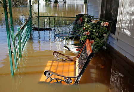 Flood waters from the swollen Tar River rise into a residential porch in the aftermath of Hurricane Matthew, in Tarboro, North Carolina on October 13, 2016. REUTERS/Jonathan Drake