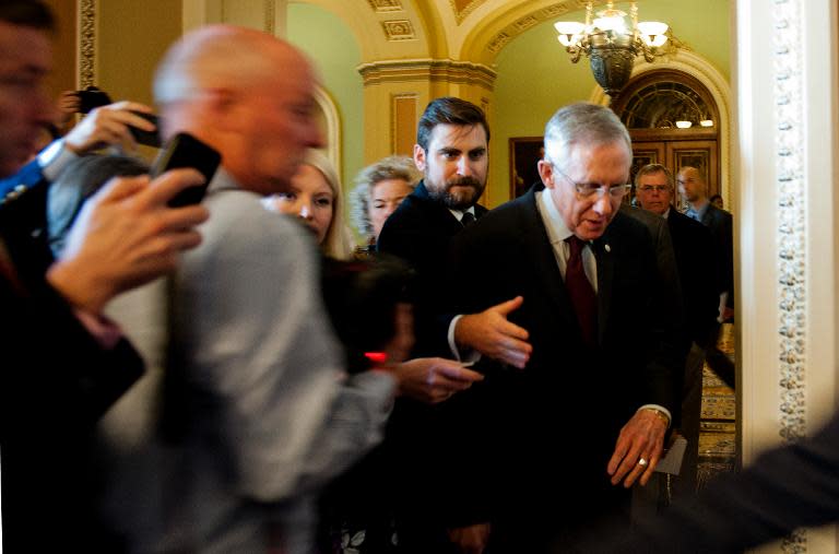 US Senate Majority Leader Harry Reid makes his way past reporters as he arrives on Capitol Hill in Washington, DC on September 30, 2013