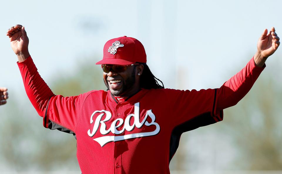 Cincinnati Reds pitcher Johnny Cueto smiles while stretching during spring training baseball practice in Goodyear, Arizona. Feb. 15, 2014.