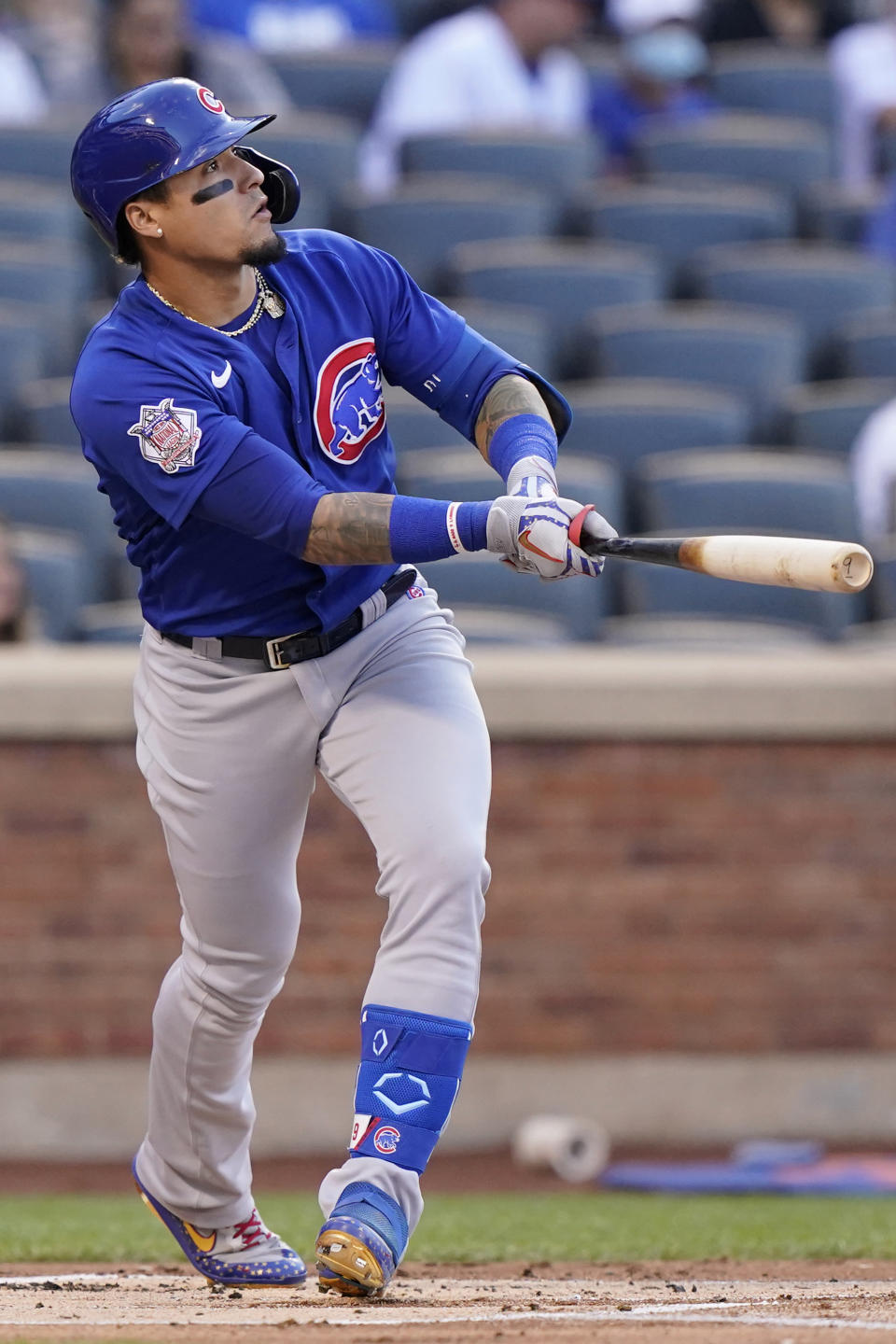 Chicago Cubs' Javier Baez watches his two-run home run off New York Mets starting pitcher Marcus Stroman during the first inning of a baseball game Thursday, June 17, 2021, in New York. (AP Photo/Kathy Willens)