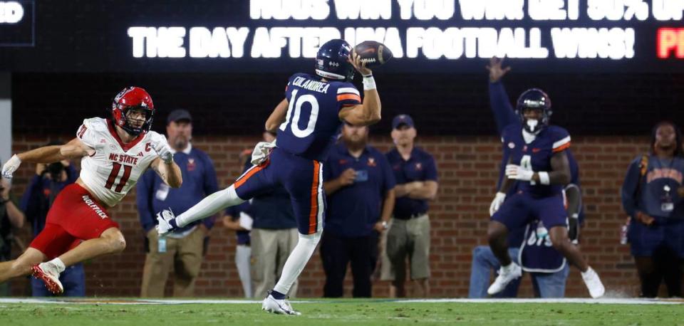 Virginia quarterback Anthony Colandrea (10) gets ready to throw a touchdown pass to wide receiver Malik Washington (4) as N.C. State linebacker Payton Wilson (11) chases him during the first half of N.C. State’s game against Virginia at Scott Stadium in Charlottesville, Va., Friday, Sept. 22, 2023.