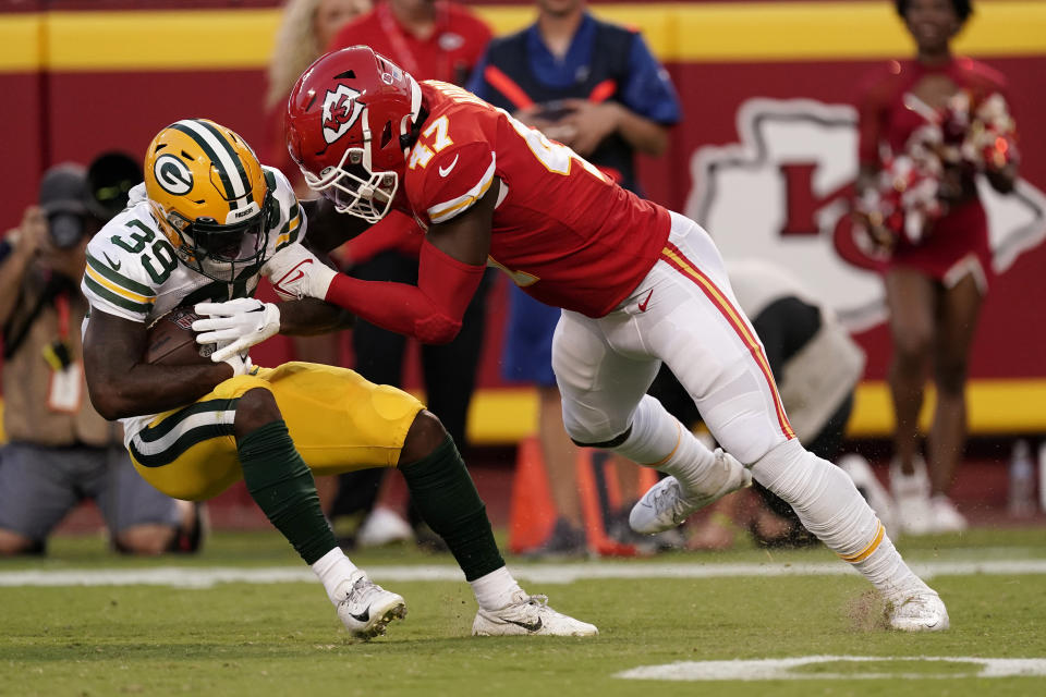 Green Bay Packers running back Tyler Goodson (39) is stopped by Kansas City Chiefs linebacker Darius Harris (47) during the first half of an NFL preseason football game Thursday, Aug. 25, 2022, in Kansas City, Mo. (AP Photo/Charlie Riedel)