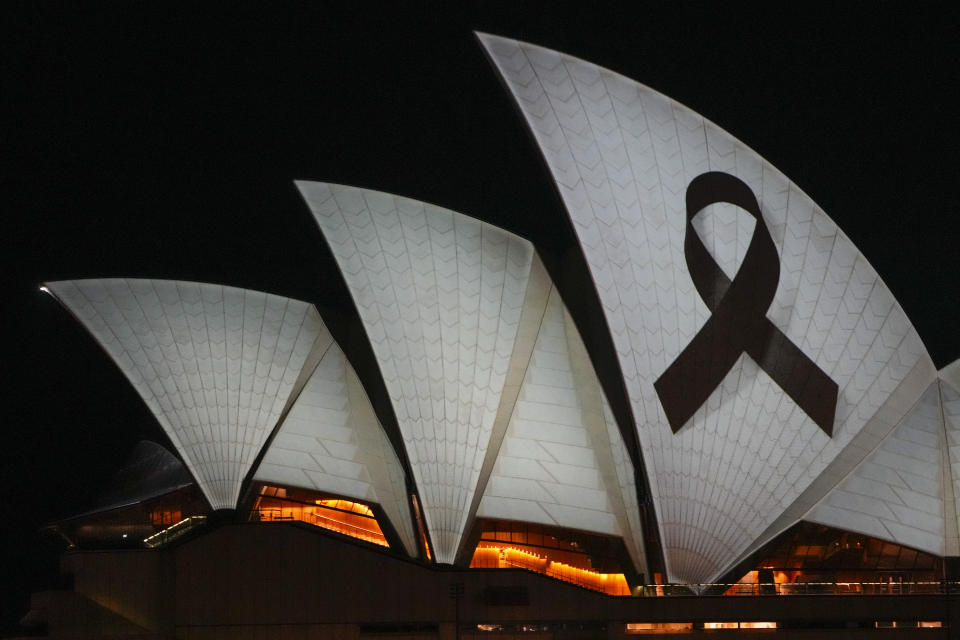 The Sydney Opera House is illuminated with a black ribbon Monday, April 15, 2024, as part of the national day of mourning following the stabbing deaths of several people at a shopping mall in Sydney's East on April 13. Australian police are examining why a lone assailant who stabbed several people to death in a busy Sydney shopping mall and injured more than a dozen others targeted women while avoiding men. (AP Photo/Mark Baker)