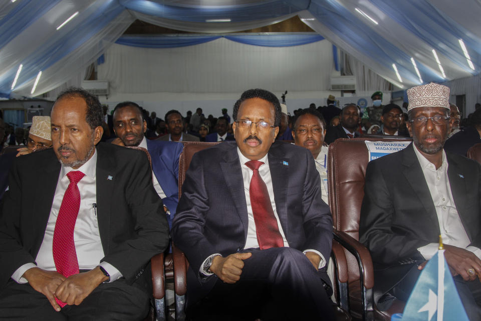 Presidential candidates, former President Hassan Sheikh Mohamud, left, incumbent leader Mohamed Abdullahi Mohamed, center, and former President Sharif Sheikh Ahmed, right, attend a voting session for the presidential election, at the Halane military camp which is protected by African Union peacekeepers, in Mogadishu, Somalia on Sunday, May 15, 2022. Legislators in Somalia are meeting Sunday to elect the country's president in the capital, Mogadishu, which is under lockdown measures aimed at preventing deadly militant attacks. (AP Photo/Farah Abdi Warsameh)