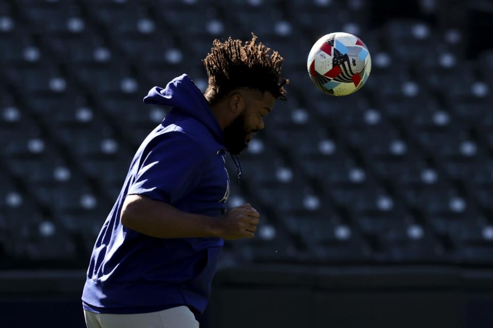 Kenley Jansen heads a soccer ball during warmups before Game 5.