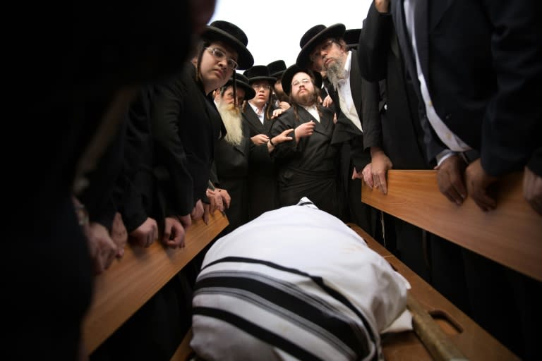 Ultra-Othodox Jews mourn over the body of 60-year old Yishaya Krashevsky during his funeral, after he was killed earlier in the day when a Palestinian drove a car into pedestrians waiting at a bus stop in Jerusalem on October 13, 2015