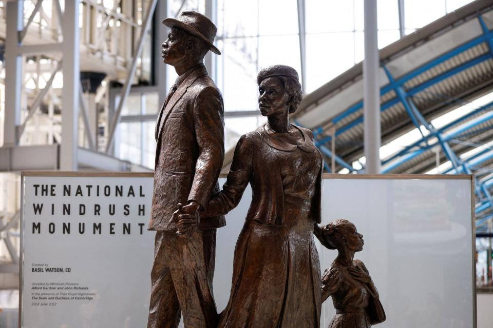 <span class="caption">The National Windrush Monument, created by Jamaican artist Basil Watson, is unveiled at Waterloo Station in London on June 22, 2022.</span> <span class="attribution"><a class="link " href="https://www.gettyimages.com/detail/news-photo/the-national-windrush-monument-created-by-jamaican-artist-news-photo/1241451640?adppopup=true" rel="nofollow noopener" target="_blank" data-ylk="slk:John Sibley/POOL/AFP via Getty Images);elm:context_link;itc:0;sec:content-canvas">John Sibley/POOL/AFP via Getty Images)</a></span>