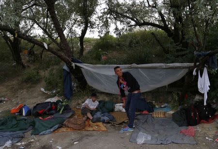 Migrants from Afghanistan gather near an abandoned brick factory in Subotica, Serbia on June 28, 2015, as they prepare to cross the border with Hungary. REUTERS/Laszlo Balogh