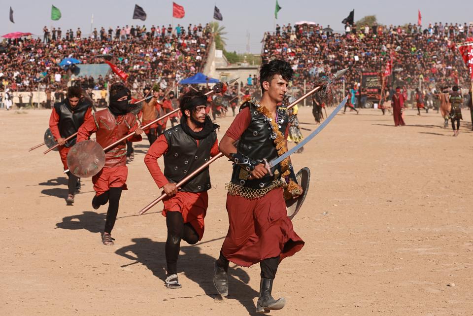 FILE - In this Sept. 10, 2019, file photo, Shiite Muslims re-enact the seventh century battle of Karbala, during the festival of Ashoura in Baghdad, Iraq. The festival of Ashoura commemorates the killing of Imam Hussein, the grandson of Prophet Muhammad at the Battle of Karbala, in present-day Iraq. Ordinarily Ashoura is marked with public celebrations around the world. But with the pandemic sweeping the globe and cases rising in Iraq, the country's top Shiite cleric, Grand Ayatollah Ali al-Sistani, encouraged people to observe the day in other ways such as watching online or televised commemorations from home. (AP Photo/Khalid Mohammed, File)